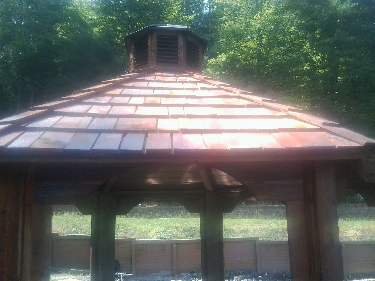 New cedar shake roof and cupola on a lakeside gazebo in Petroleum
